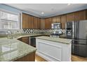 Well-equipped kitchen featuring granite countertops, stainless steel appliances, and a center island at 213 Crossandra Ave, Summerville, SC 29483