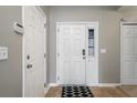 Bright entryway featuring neutral walls, tile flooring, a white front door with glass panes, and convenient coat closet at 240 Island Green Rd, Goose Creek, SC 29445