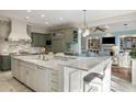 Open kitchen with a large marble island, modern appliances, and custom cabinetry at 2455 The Haul Over, Seabrook Island, SC 29455