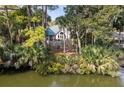 Picturesque waterfront home with a balcony, lush trees, and an in-ground pool at 2455 The Haul Over, Seabrook Island, SC 29455