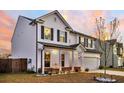 Charming two-story home featuring classic white siding, a well-manicured lawn, and an attached two-car garage at 315 Silent Bluff Dr, Summerville, SC 29486