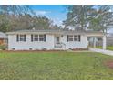 Inviting home with a covered carport, freshly painted white exterior, and green lawn at 337 Cessna Ave, Charleston, SC 29407