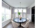 Elegant dining area with a round table, neutral chairs, and three large windows offering ample light at 338 Hillman Trail Dr, Moncks Corner, SC 29461