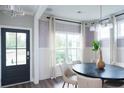 Bright dining room featuring a modern table setting, large windows, and stylish decor at 338 Hillman Trail Dr, Moncks Corner, SC 29461