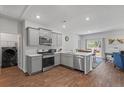 Modern kitchen features stainless steel appliances, gray cabinets, and an adjacent dining area at 350 Bering Ln, Summerville, SC 29486
