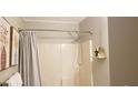 Clean bathroom featuring a shower with neutral curtain and minimalist decor at 40 Bee St # 309, Charleston, SC 29403