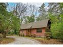Charming log cabin featuring a gable roof and inviting front porch at 415 W Carolina Ave, Summerville, SC 29483