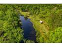 Aerial view of property with pond, mature trees, parked RV, and various outbuildings at 4304 River Rd, Johns Island, SC 29455