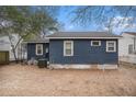 View of the backyard with blue siding, small area, and minimal landscaping, offering potential for customization at 4530 Holly St, North Charleston, SC 29405