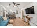 Open-concept living area with hardwood floors and modern decor, showcasing seamless flow to the kitchen at 4530 Holly St, North Charleston, SC 29405
