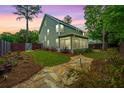 Lovely backyard featuring stone walking path, manicured grass, and a screened-in porch at 616 W 2Nd N St, Summerville, SC 29483