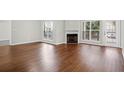 Spacious living room features a fireplace, hardwood floors, and neutral paint colors at 700 Daniel Ellis Dr # 8107, Charleston, SC 29412