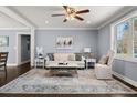 Cozy living room with a decorative rug, comfortable sofa, and a ceiling fan for added comfort and style at 705 Melrose Dr, Charleston, SC 29414