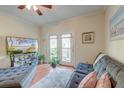 Comfortable living room with a gray sofa, various potted plants, and a patio door at 949 E Estates Blvd # 303, Charleston, SC 29414