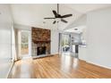 Bright and airy living room with hardwood floors, a brick fireplace, and sliding doors that lead to the outside at 112 Chownings Ln, Goose Creek, SC 29445
