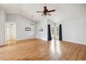 Spacious living room with vaulted ceilings, hardwood floors, and natural light coming through the sliding glass doors at 112 Chownings Ln, Goose Creek, SC 29445