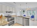Bright kitchen features stainless steel appliances, stone countertops, and an adjacent dining area at 1137 Windsome Pl, Mount Pleasant, SC 29464