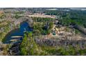 Scenic aerial view of a lakefront property, nestled among the trees and featuring ample green space at 120 Rancho Hippey Way, Saint George, SC 29477