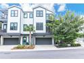 Stunning townhouse with a two-car garage, lovely landscaping, and gray accents, creating curb appeal at 1201 Gatch Ct, Mount Pleasant, SC 29464