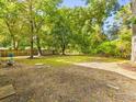 Large backyard with a wooden fence and scattered trees, offering privacy at 1294 Horseshoe Bnd, Mount Pleasant, SC 29464