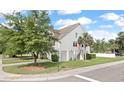 Charming two-story home featuring a bright red door, side entry and a well-maintained lawn at 1415 Widows Ct, Johns Island, SC 29455