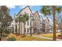 Attractive row of brick townhomes with palm trees, sidewalks and manicured landscaping at 1510 Martel St, Mount Pleasant, SC 29464