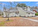 Stylish home exterior with neutral siding, white trim, and a cozy front entrance at 1545 Sterling Oaks Dr, Moncks Corner, SC 29461