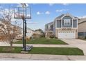Inviting two-story home with neat landscaping, a basketball hoop, and an attached two-car garage at 1559 Innkeeper Ln, Johns Island, SC 29455