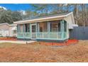 Charming home with a screened-in porch and meticulously landscaped yard at 1618 Yost Ln, Johns Island, SC 29455