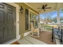 Charming front porch with rocking chairs, ceiling fan and space for relaxing and enjoying the outdoors at 206 President Cir, Summerville, SC 29483