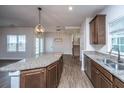 Well-lit kitchen showcasing granite countertops, stainless steel appliances, and rich wood cabinets at 219 Corvus St, Summerville, SC 29483