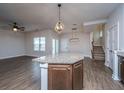 Open-concept living room featuring a stylish ceiling fan, hardwood floors, and natural light at 219 Corvus St, Summerville, SC 29483
