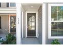 Up close of the front door with black frame, glass panes, and view of the street at 227 Abercom Place Dr, Moncks Corner, SC 29461
