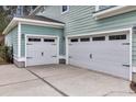 Spacious two-car garage features white doors and convenient access to the home at 295 Calm Water Way, Summerville, SC 29486