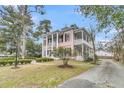 Two-story home featuring columns, double porches and manicured landscaping at 301 E Richardson Ave, Summerville, SC 29483