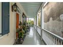 Inviting covered porch with rocking chairs, plants, and views of a private garden at 31 Hasell St, Charleston, SC 29401