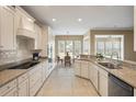 Well-lit kitchen boasts tile floors, granite countertops, and modern appliances at 323 Waterlily Way, Summerville, SC 29486