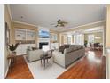 Spacious living room featuring built-in shelving, a fireplace, and hardwood flooring at 323 Waterlily Way, Summerville, SC 29486