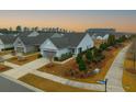 Beautiful single-Gathering home featuring a well-manicured lawn, mature trees, and an inviting facade in a suburban neighborhood at 402 Switchgrass Dr, Summerville, SC 29486