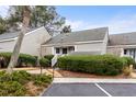 Charming exterior view of townhome featuring well-maintained landscaping and assigned parking space at 461 Double Eagle Trce, Johns Island, SC 29455