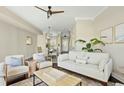 Inviting living room with neutral decor, comfortable seating, and modern ceiling fan at 4993 Lake Palmetto, North Charleston, SC 29418