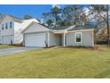 Charming single-Gathering home featuring a two-car garage and a well-maintained front lawn at 5032 Scow Ct, Summerville, SC 29485
