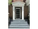 Close-up of the home's front door and entryway with stairs leading to the entrance at 56 Laurens St, Charleston, SC 29401