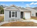 Lovely single-story home featuring gray siding, black shutters, and an attached one car garage at 604 Red Mulberry Rd, Moncks Corner, SC 29461