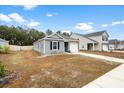 Well-kept home with a driveway and a lawn, complemented by the surrounding neighborhood at 604 Red Mulberry Rd, Moncks Corner, SC 29461