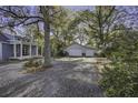 Exterior featuring an accessory building, rock landscaping, and a gravel driveway at 6094 Chisolm Rd, Johns Island, SC 29455