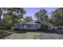 Charming single story home with light blue siding and mature trees on a large lot at 6094 Chisolm Rd, Johns Island, SC 29455