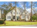 Attractive two-story home featuring manicured lawn and a classic architectural style with symmetrical windows at 6917 Tanner Hall Blvd, Hanahan, SC 29410