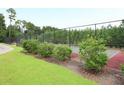 Outdoor tennis court surrounded by green trees and lush landscaping at 6934 Tanner Hall Blvd, Hanahan, SC 29410