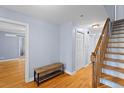 Hallway features hardwood floors, a wooden bench, and staircase at 7537 Parkers Ferry Rd, Adams Run, SC 29426